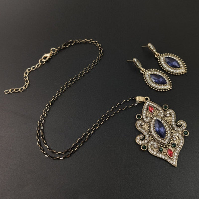 Necklace chain with ornate blue pendant and matching drop earrings set