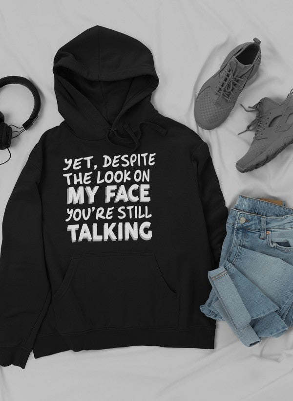 Black hoodie with front slogan graphic and drawstring hood