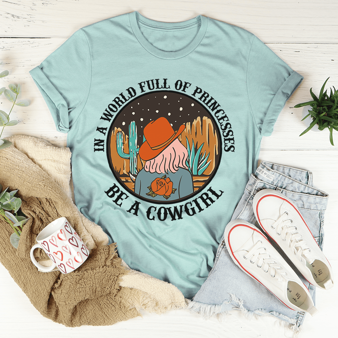 Dusty blue cowgirl T-shirt with circular cactus and cowboy hat graphic