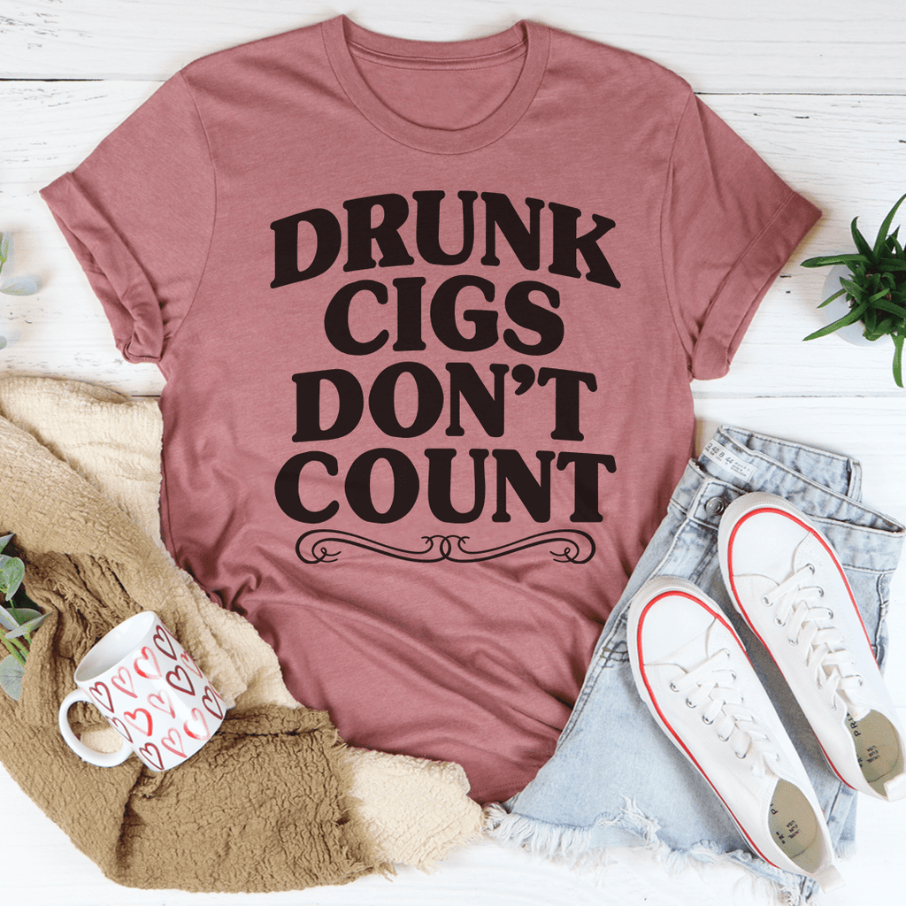 Mauve graphic T-shirt with bold black 'DRUNK CIGS DON'T COUNT' lettering