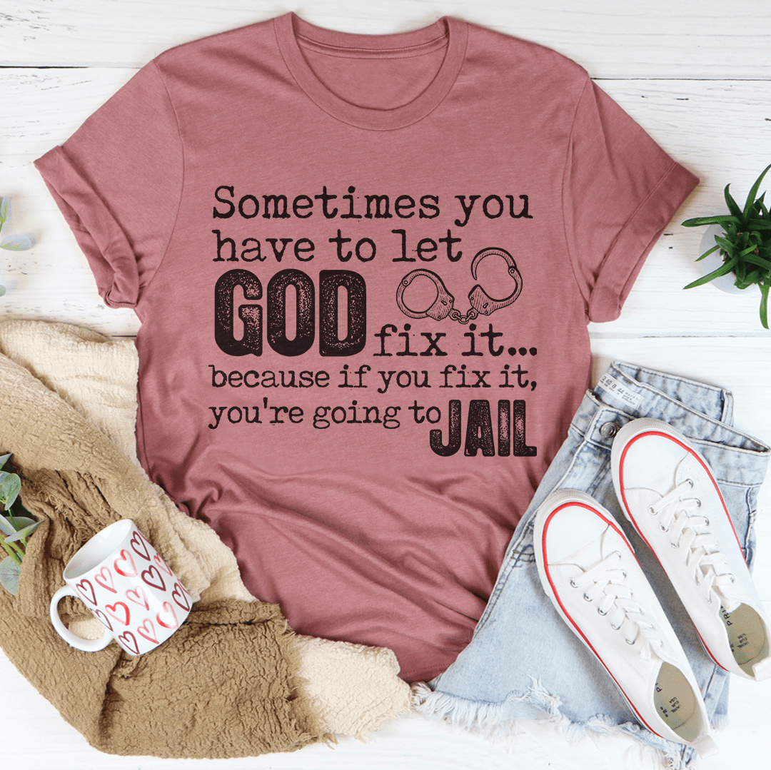 Mauve crew-neck T-shirt with 'GOD fix it...' and 'JAIL' graphic print