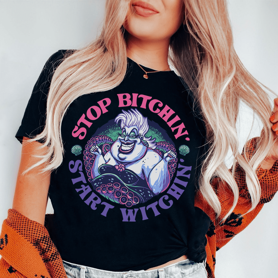 Black T-shirt with circular witch character graphic and purple arched text