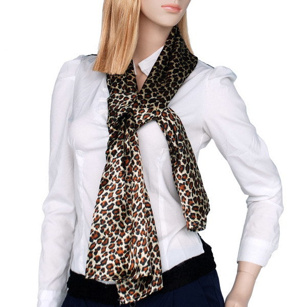 Leopard print silk scarf worn as neck bow, dark brown with cream and rust spots