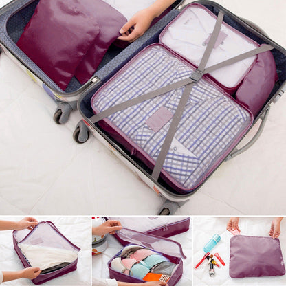 Packing cubes inside a rolling suitcase with burgundy pouches and zipped compartments.