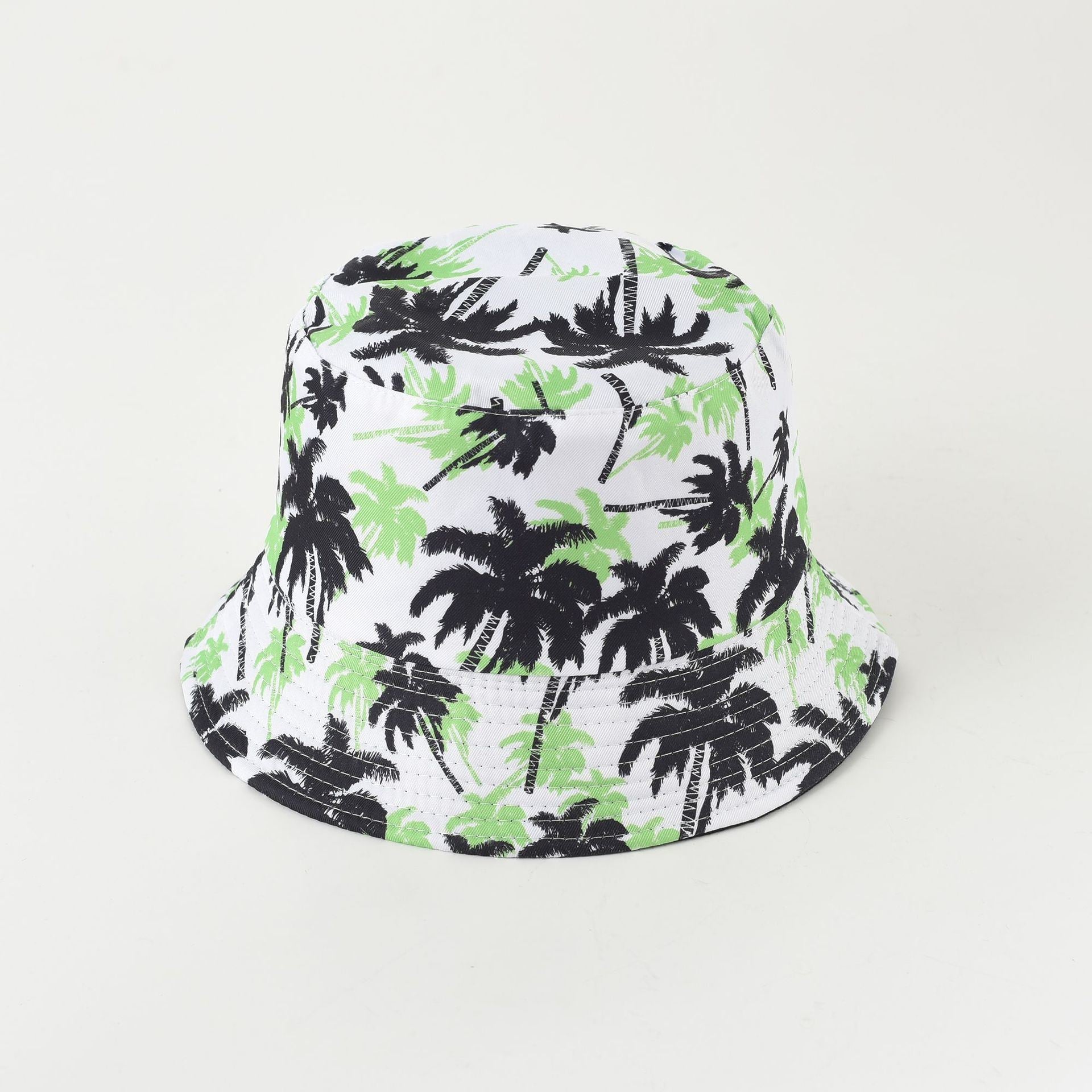 White fisherman bucket hat with green foliage and black palm silhouettes