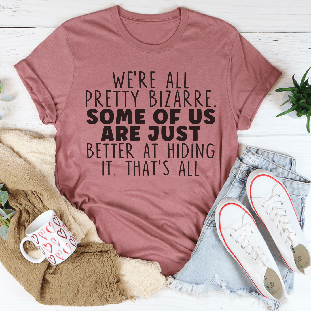 Mauve T-shirt with bold front graphic text: “We’re all pretty bizarre…”
