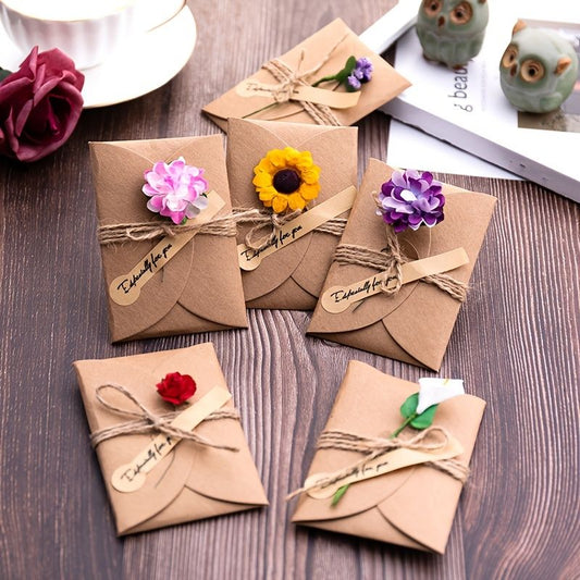 Set of kraft paper envelope cards with assorted flower appliques and twine bows