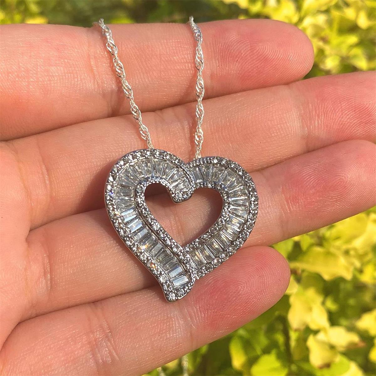 Heart pendant necklace with silver-tone heart and faux diamond halo on openwork center