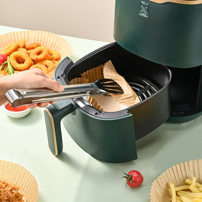 Brown round air fryer paper liner mat being placed in basket