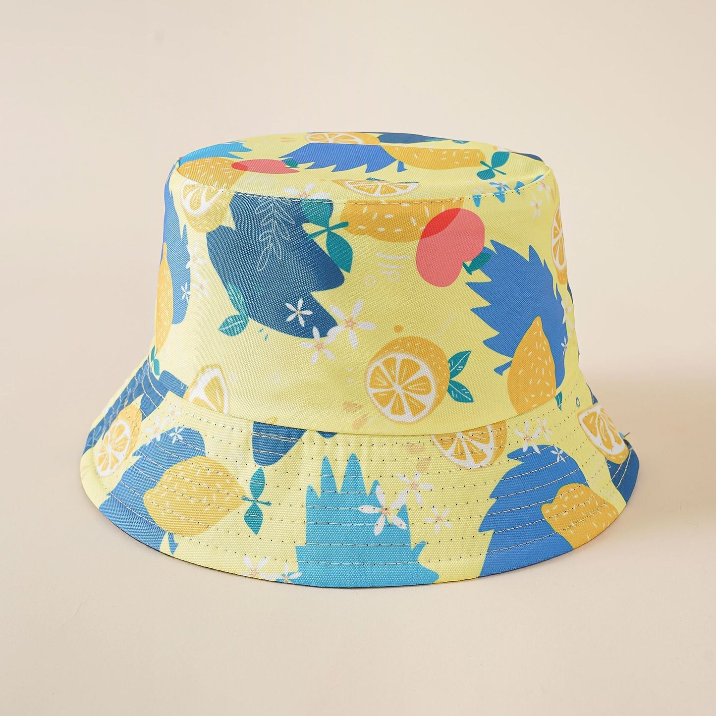 Bucket fisherman hat with blue and yellow fruit print, wide brim, reversible style