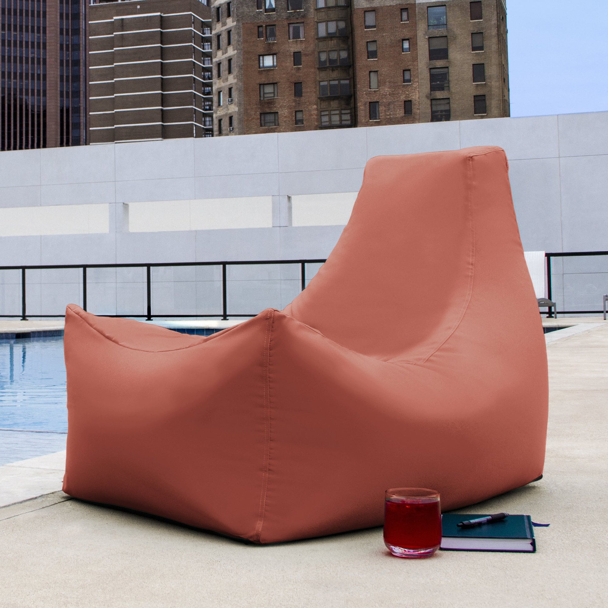 Coral bean bag patio chair with high backrest and relaxed wedge shape