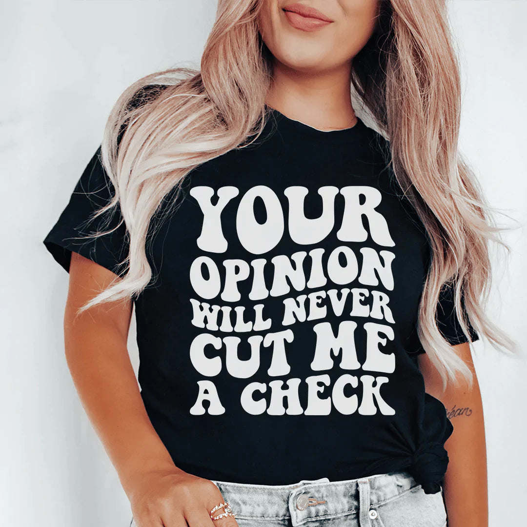 Black crew-neck T-shirt on model with large white slogan text: YOUR OPINION WILL NEVER CUT ME