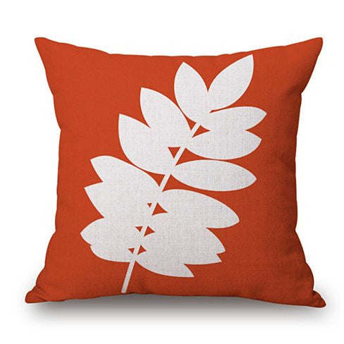 Orange leaf cushion cover with large white floral leaf pattern.