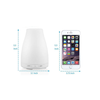 Aromatherapy-free humidifier with size measurements shown, and phone for scale.