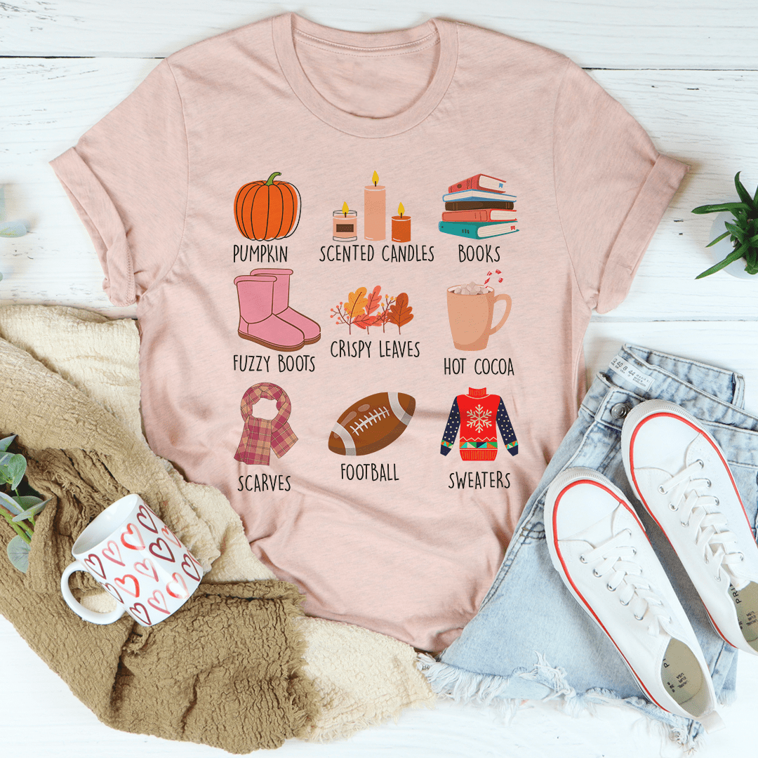 Mauve fall graphic T-shirt showing pumpkin, scented candles, books, crispy leaves, cocoa