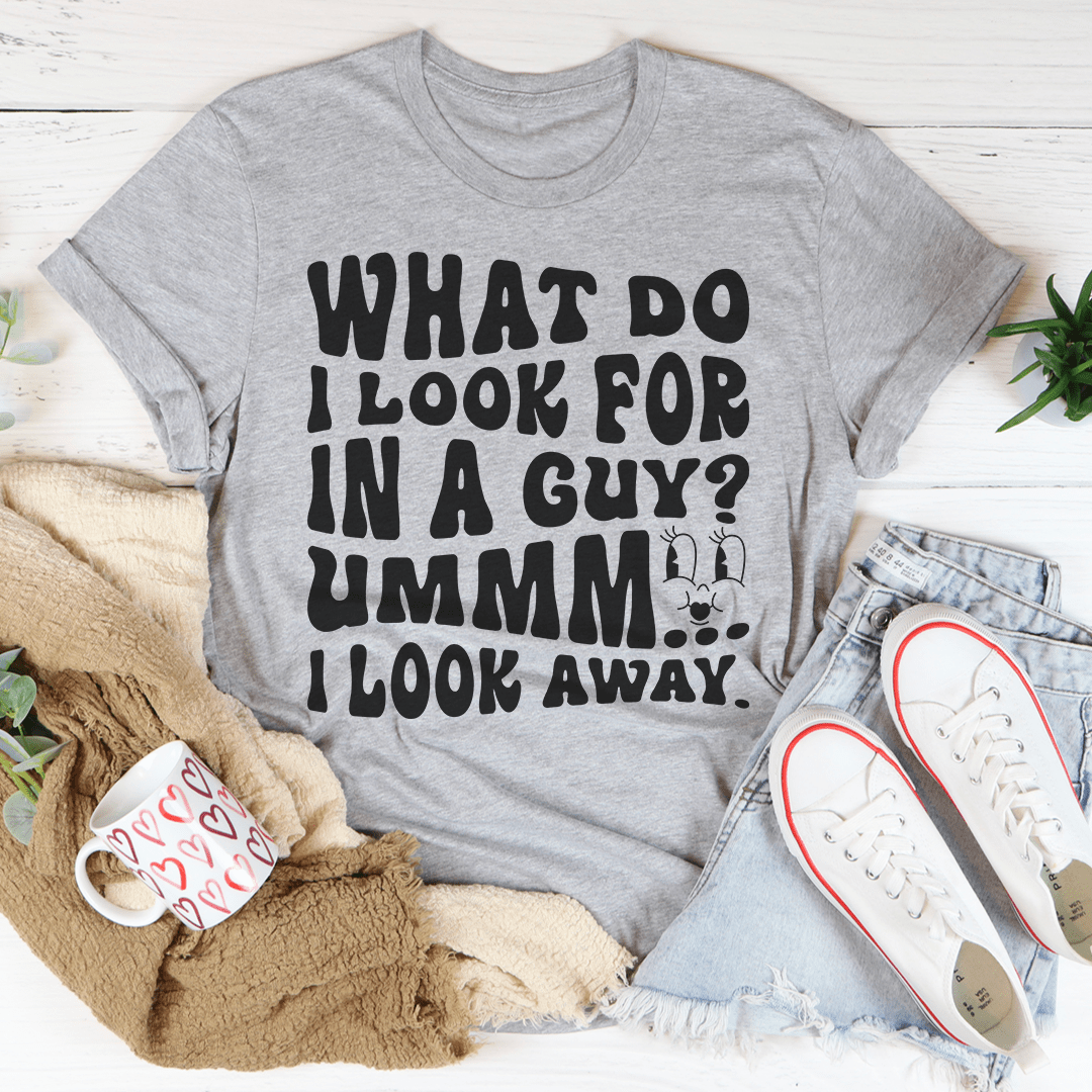 Gray crew-neck graphic T-shirt with bold front text: "What do I look for in a guy?"