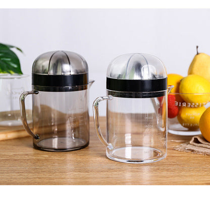 Two clear citrus juicer pitchers with black lids, handles, and stainless reamer domes
