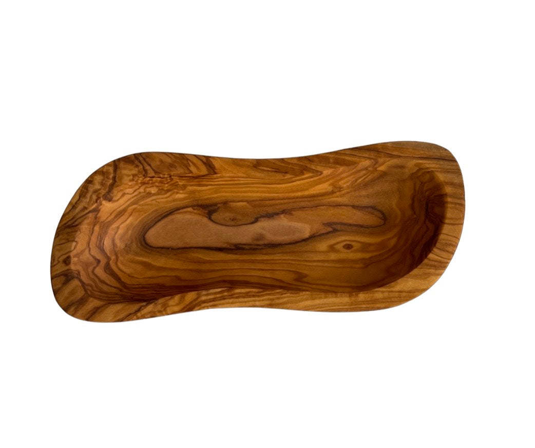 Olive wood multi-purpose bowl with smooth shallow interior and swirling grain, angled.