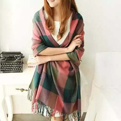 Reversible shawl in pink and green plaid stripes with fringe, draped on model