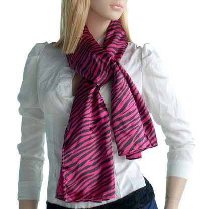 Silk scarf with magenta zebra stripes draped around model’s neck, small wrap
