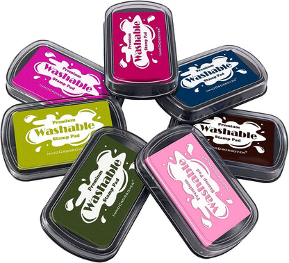 Washable ink stamp pad set of seven colors in black cases with rounded lids