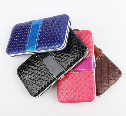 Four nail clipper set hard cases in blue, black, red, and brown, closed