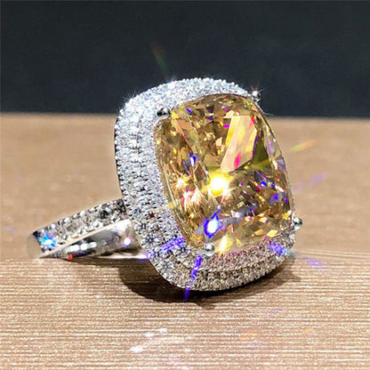 Rhinestone bridal ring with yellow faceted cushion center stone and silver pavé halo