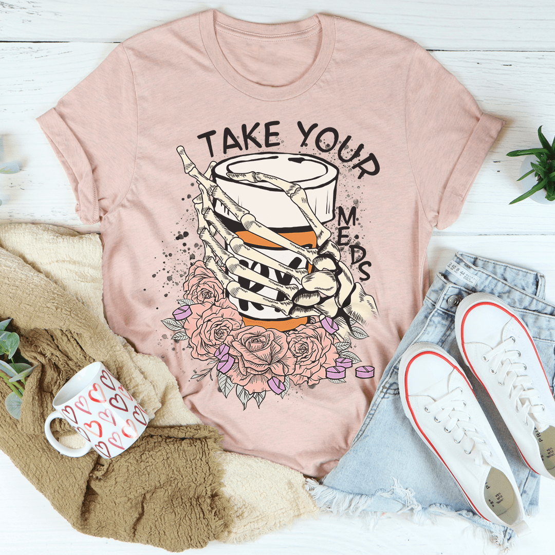 Peach crew-neck T-shirt with skeleton hand graphic and detailed rose bouquet.