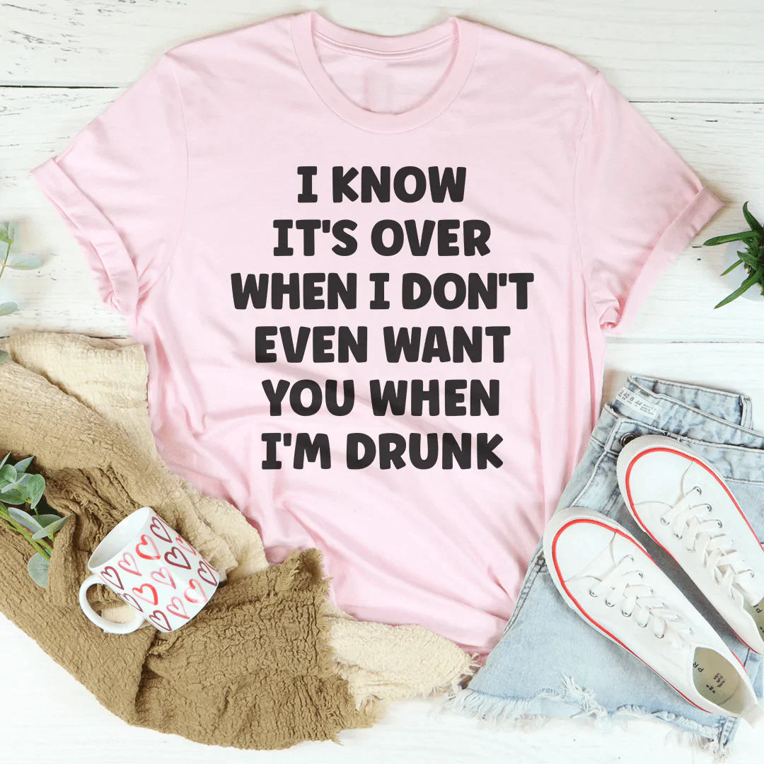 Pink graphic t-shirt with bold slogan text on the front, crew neck short sleeves