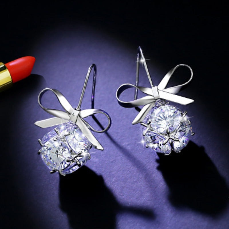Silver-tone bow drop earrings with ribbon bow and large round zircon stones