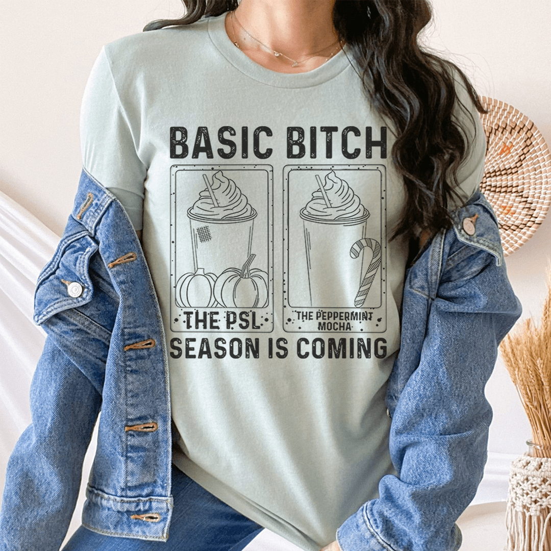 Heather dusty blue crewneck graphic T-shirt with “BASIC BITCH” and “SEASON IS COMING”