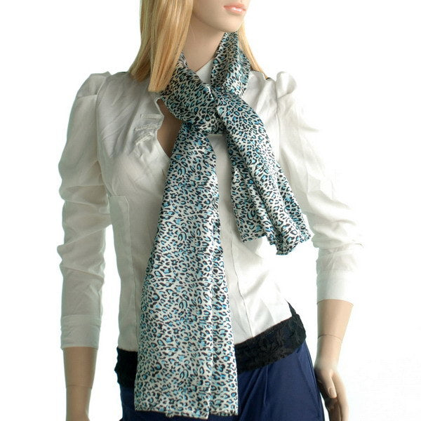Leopard print silk scarf in teal and cream worn long with loose end drape.