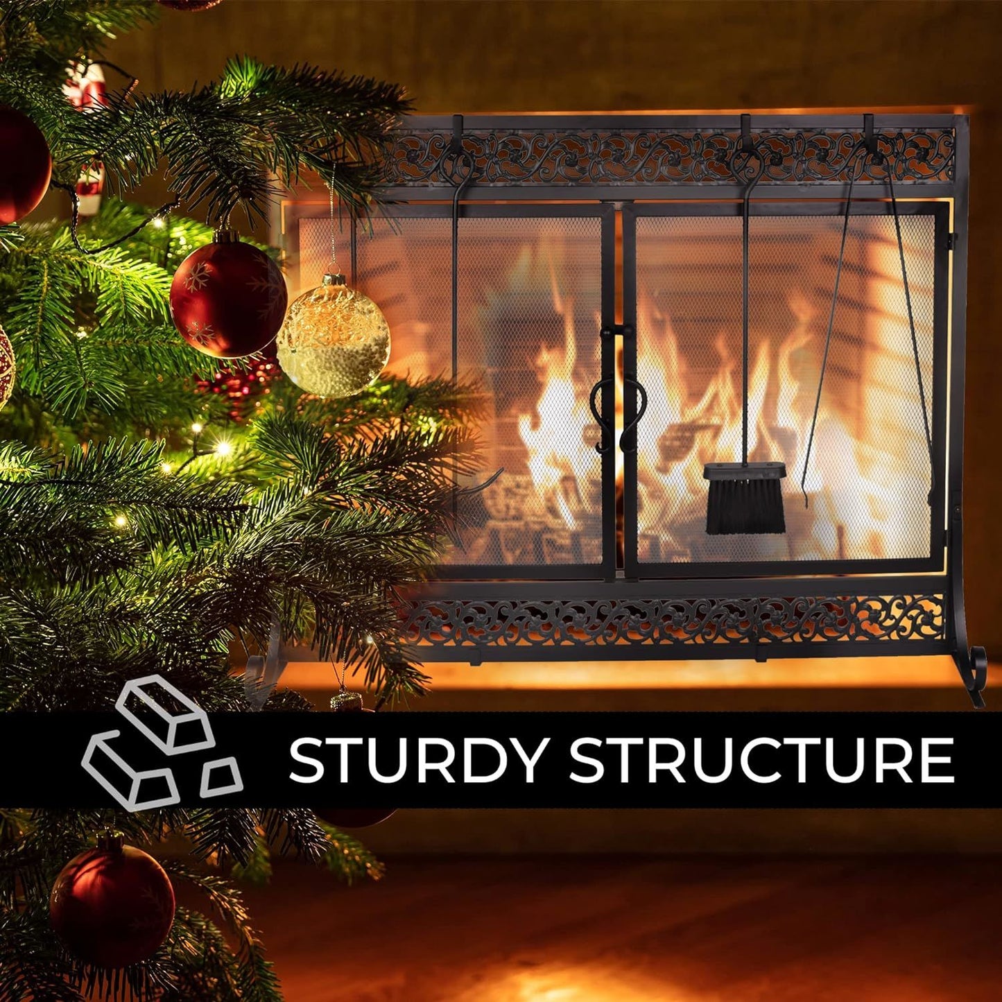 Black metal fireplace screen with two mesh doors and decorative scrollwork paneling