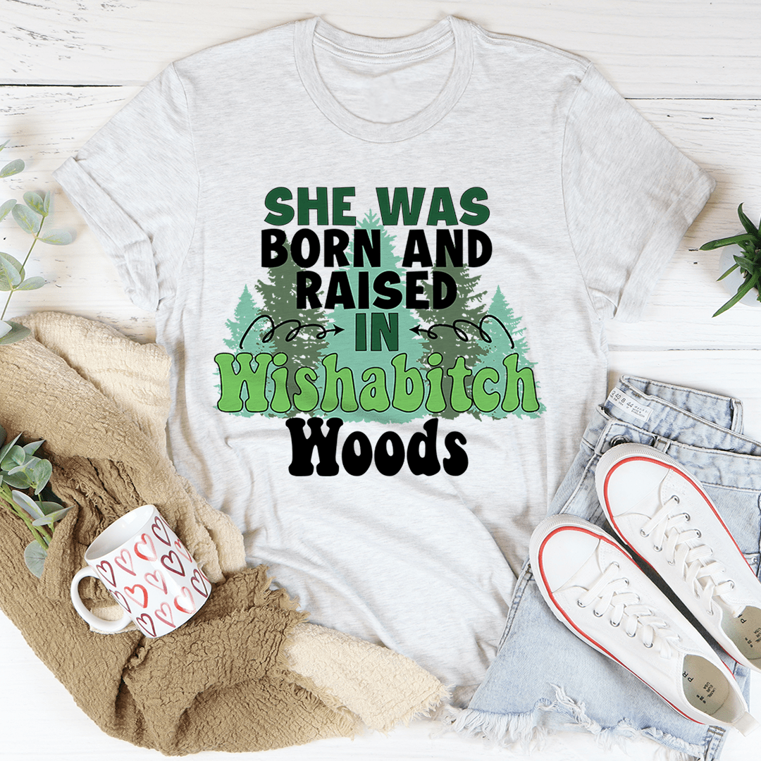 Light gray graphic T-shirt: 'She Was Born and Raised in Wishabitch Woods' trees