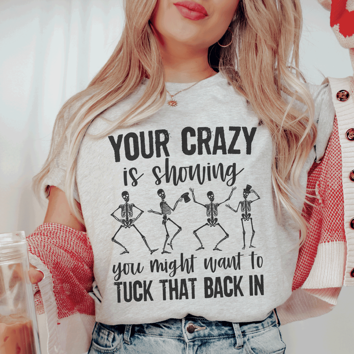 Light heather graphic t-shirt with skeleton dancers and 'Tuck that back in' text.