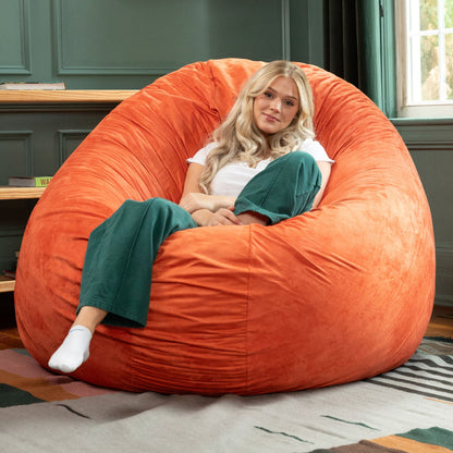 Mandarin orange cocoon bean bag chair with gathered plush cover and rounded form