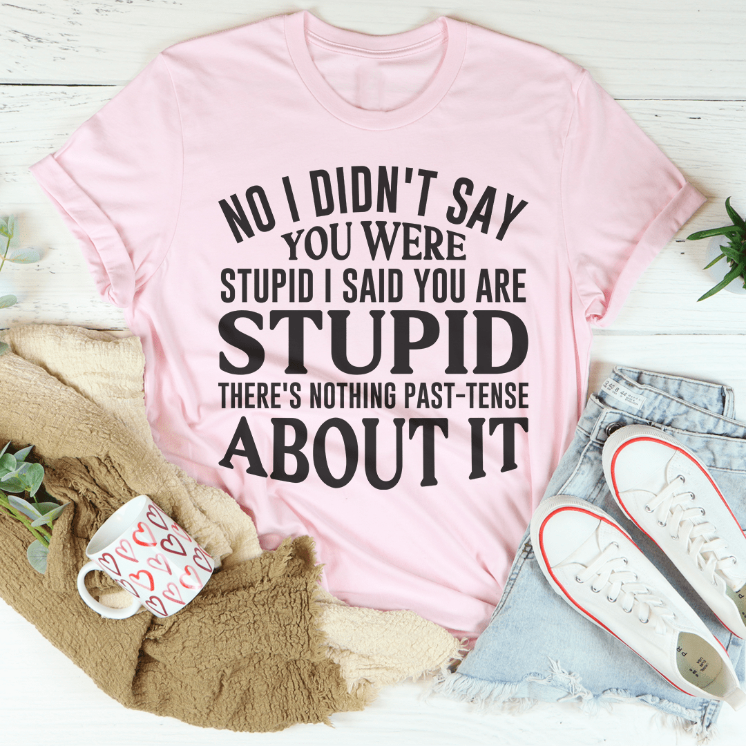 Pink crewneck T-shirt with large black quote graphic across front.