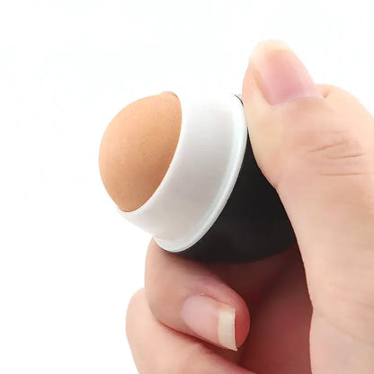 White skincare applicator with tan sponge tip held in hand