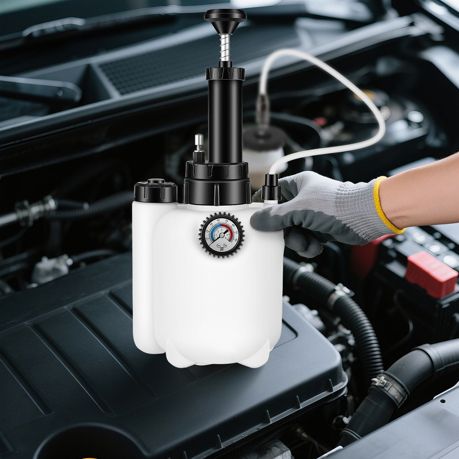 Automotive brake bleeder kit with white waste bottle, black pump, pressure gauge, glove