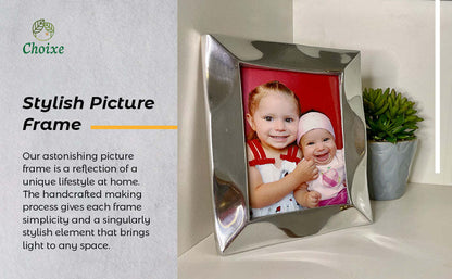 Silver picture frame holding a child photo with red backing