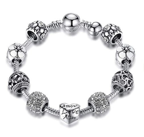 Silver-tone charm bracelet with heart centerpiece and flower bead charms