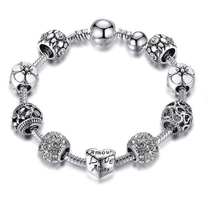 Silver-tone charm bracelet with heart centerpiece and flower bead charms