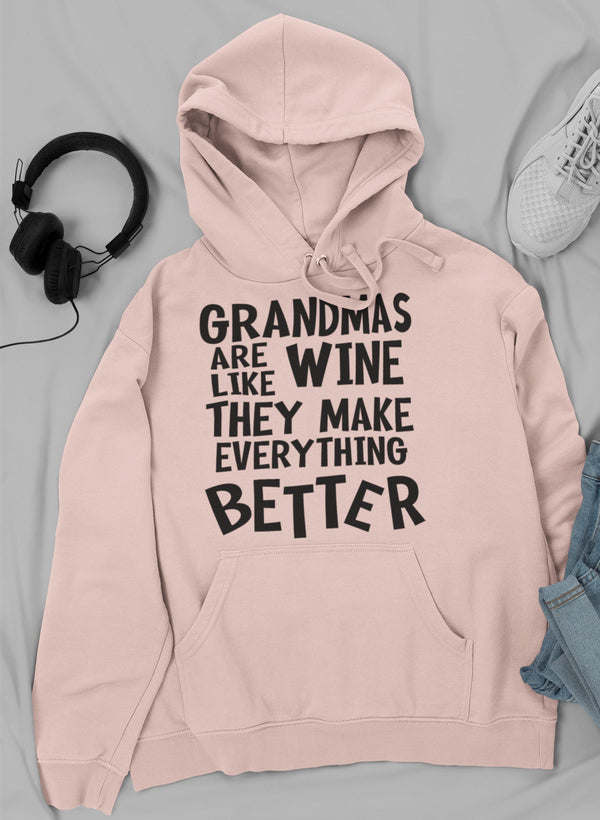Light pink pullover hoodie with front “Grandmas are like wine” text graphic and kangaroo pocket