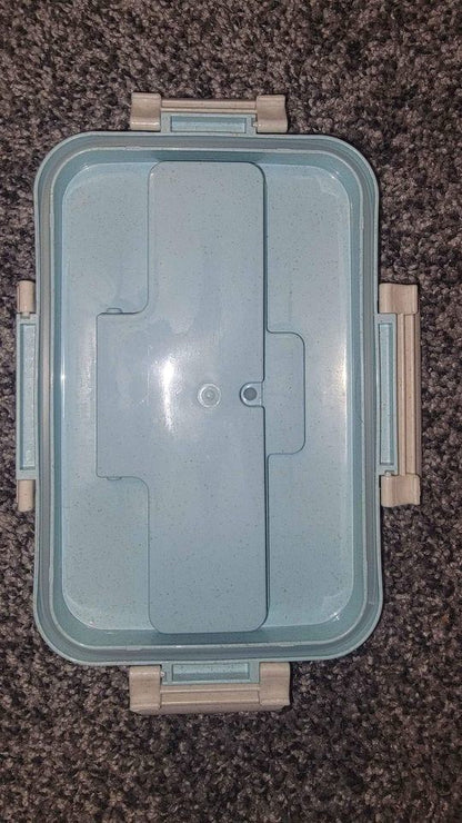 Blue bento box closed with integrated divider inside