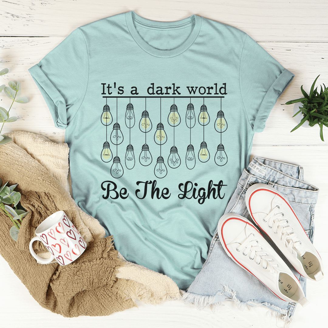 Heather dusty blue crew-neck graphic t-shirt with bulbs and 'Be The Light' lettering.