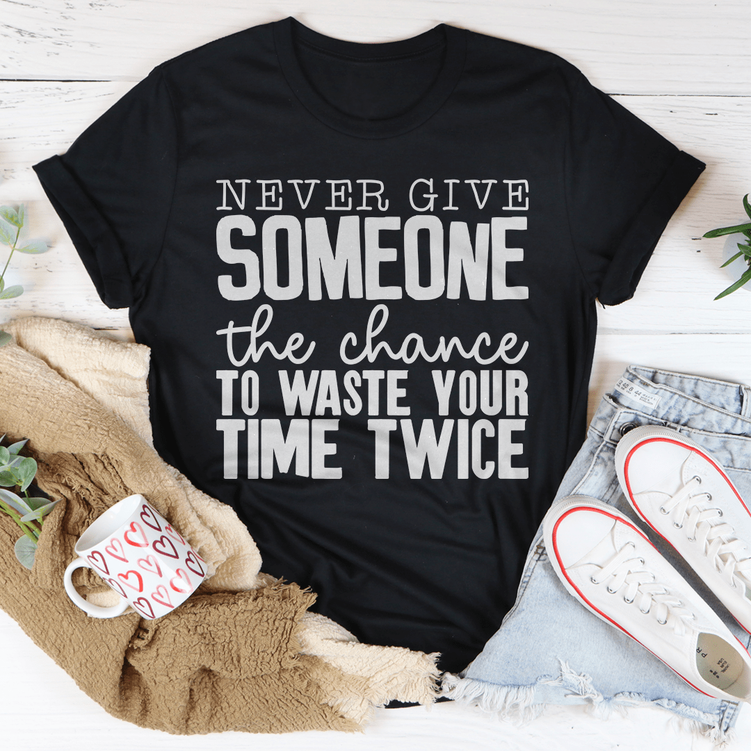 Black crewneck T-shirt with bold white slogan graphic, 'Never Give Someone' text