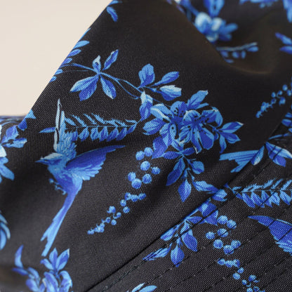 Floral fisherman hat fabric, blue leaves and flowers on dark background