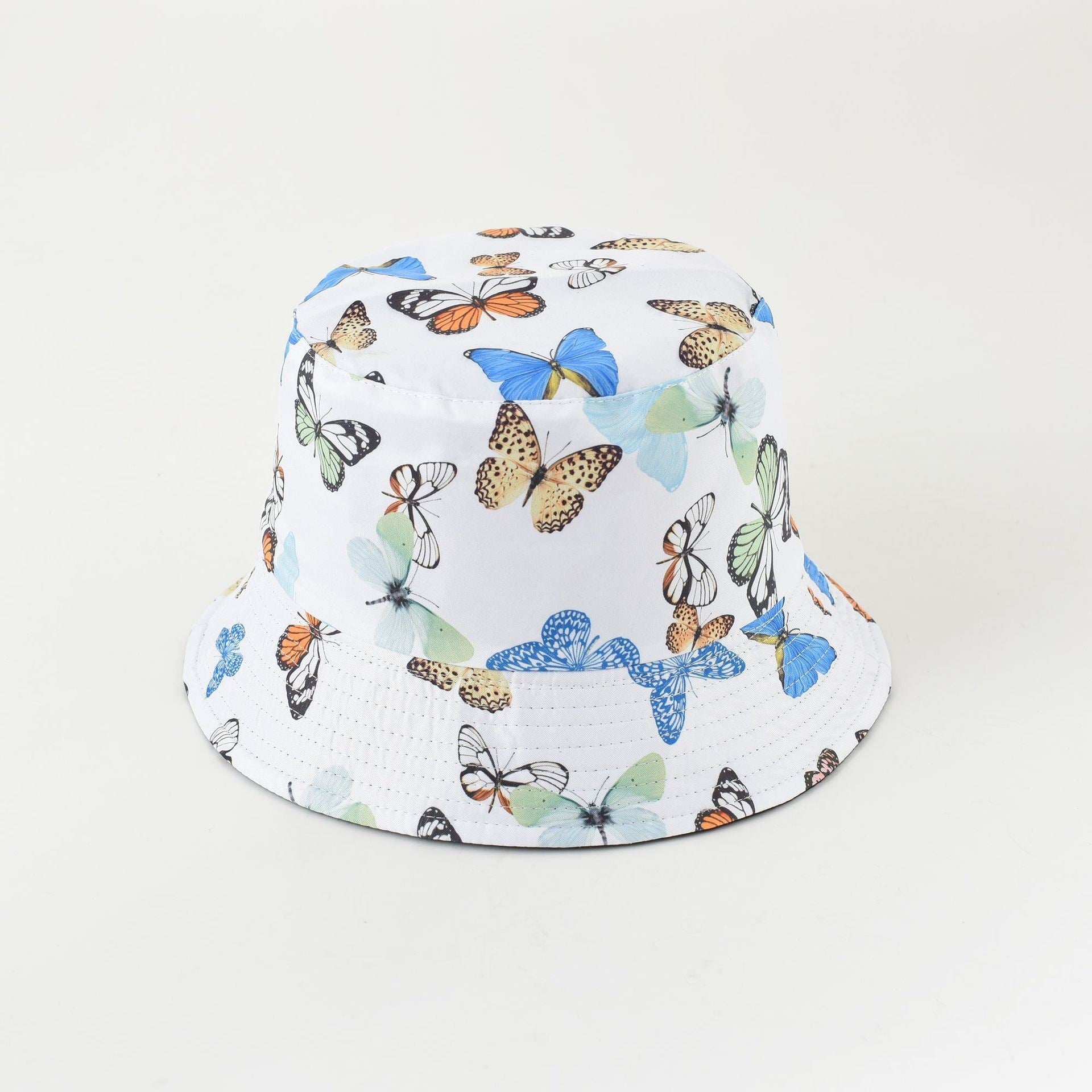 Butterfly bucket hat with white base and multicolor butterfly print, wide brim
