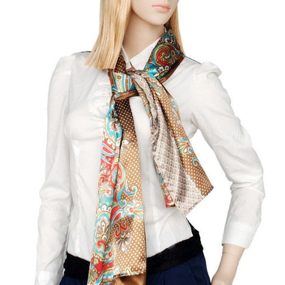 Silk scarf worn around neck, paisley and dot pattern in teal, red, and brown