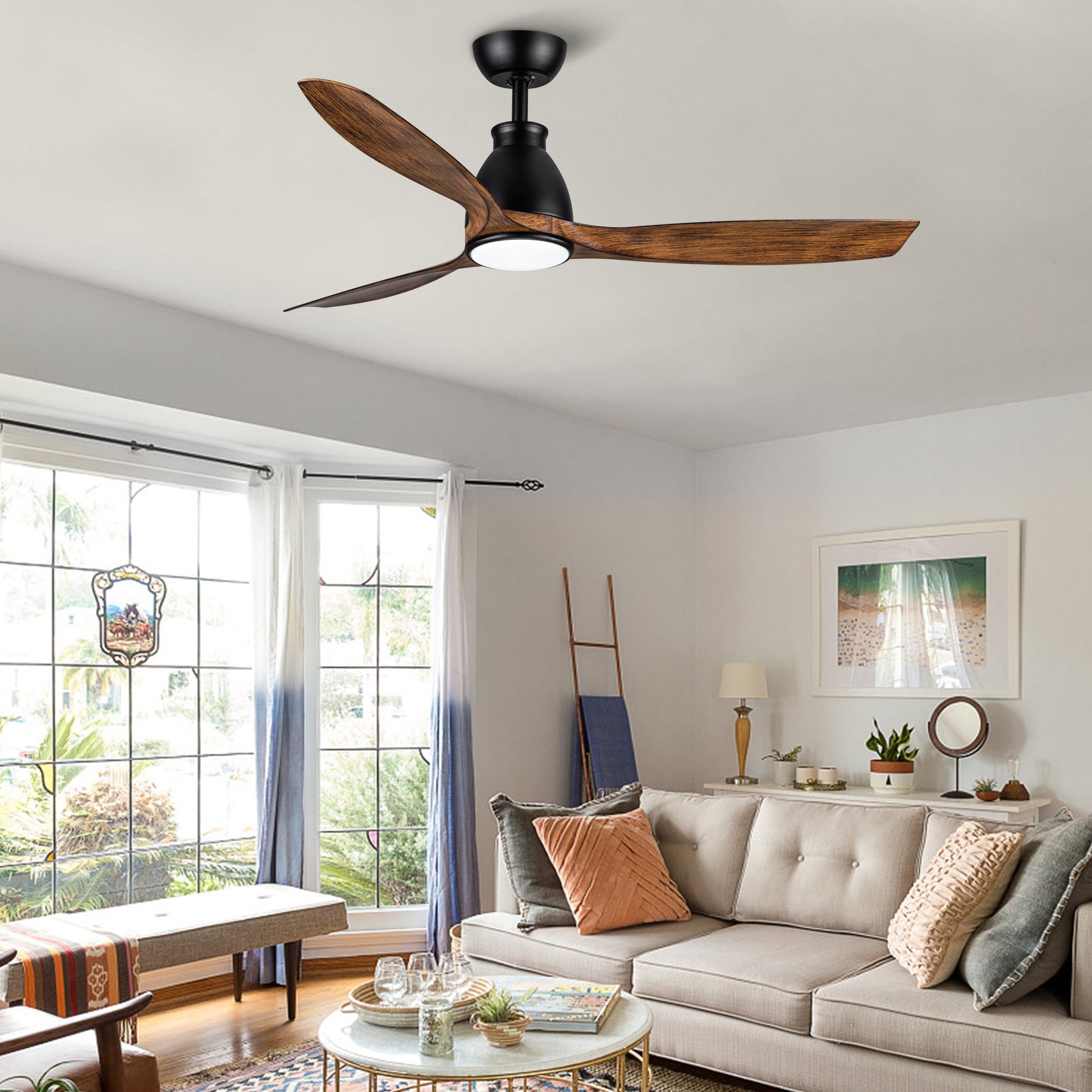 Black ceiling fan with wood blades and integrated light in a living room